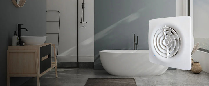 Bathroom with a white freestanding bathtub, wooden cabinet, and a white exhaust fan on the floor.