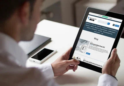 Person using a tablet with a website displayed on a desk